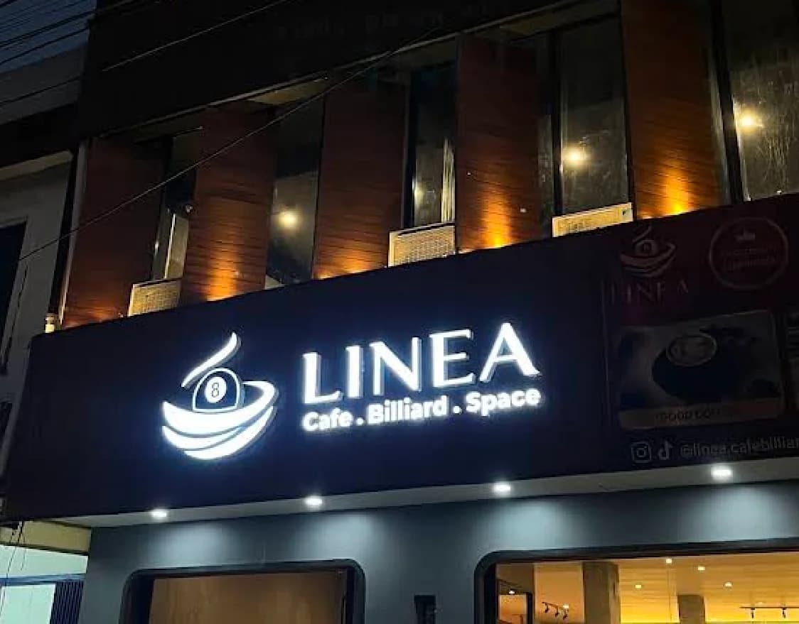 Fasad LINEA Cafe Billiard pada malam hari dengan papan nama menyala